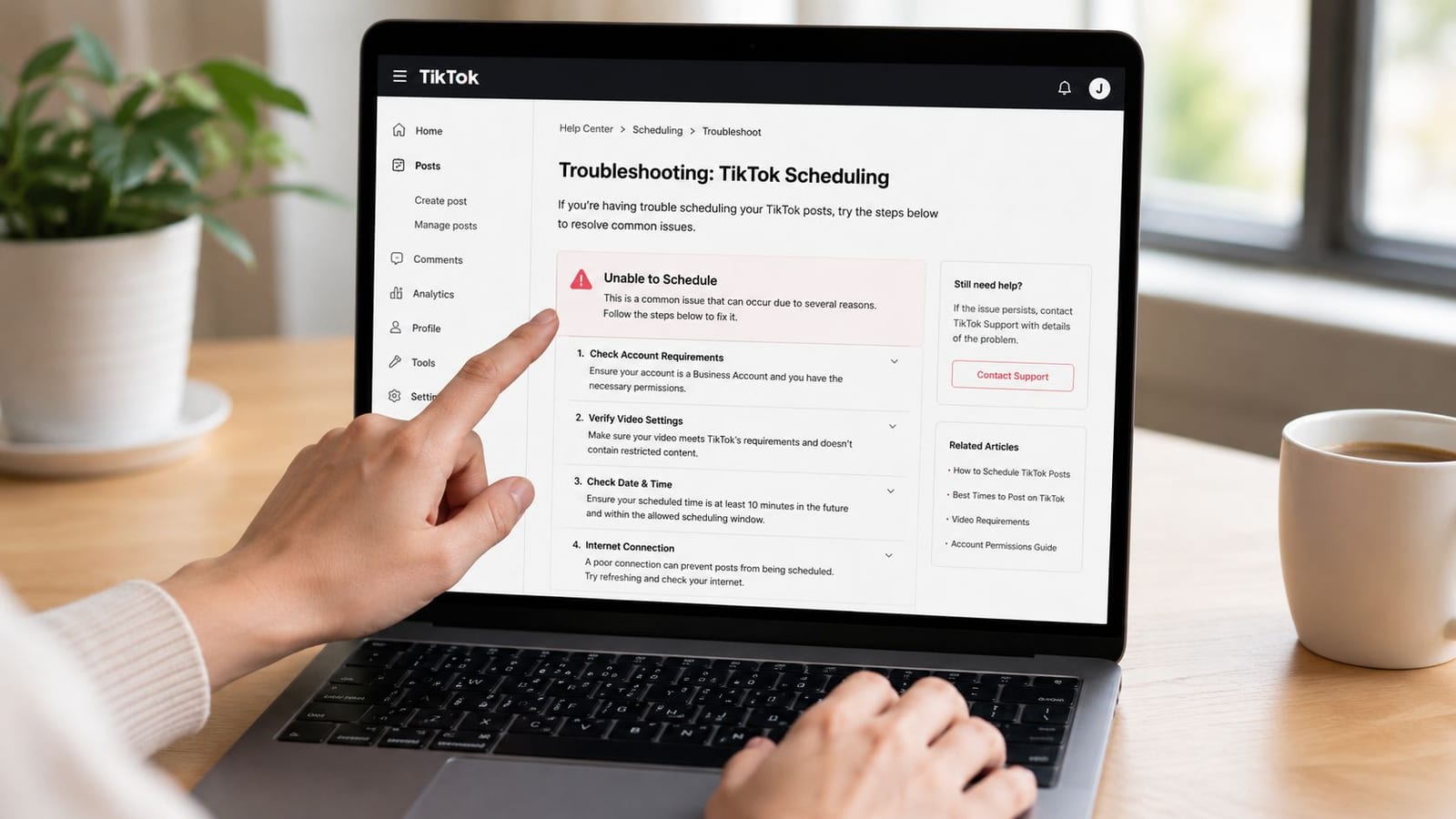 A person using a laptop to read a TikTok help center troubleshooting guide for scheduling posts.